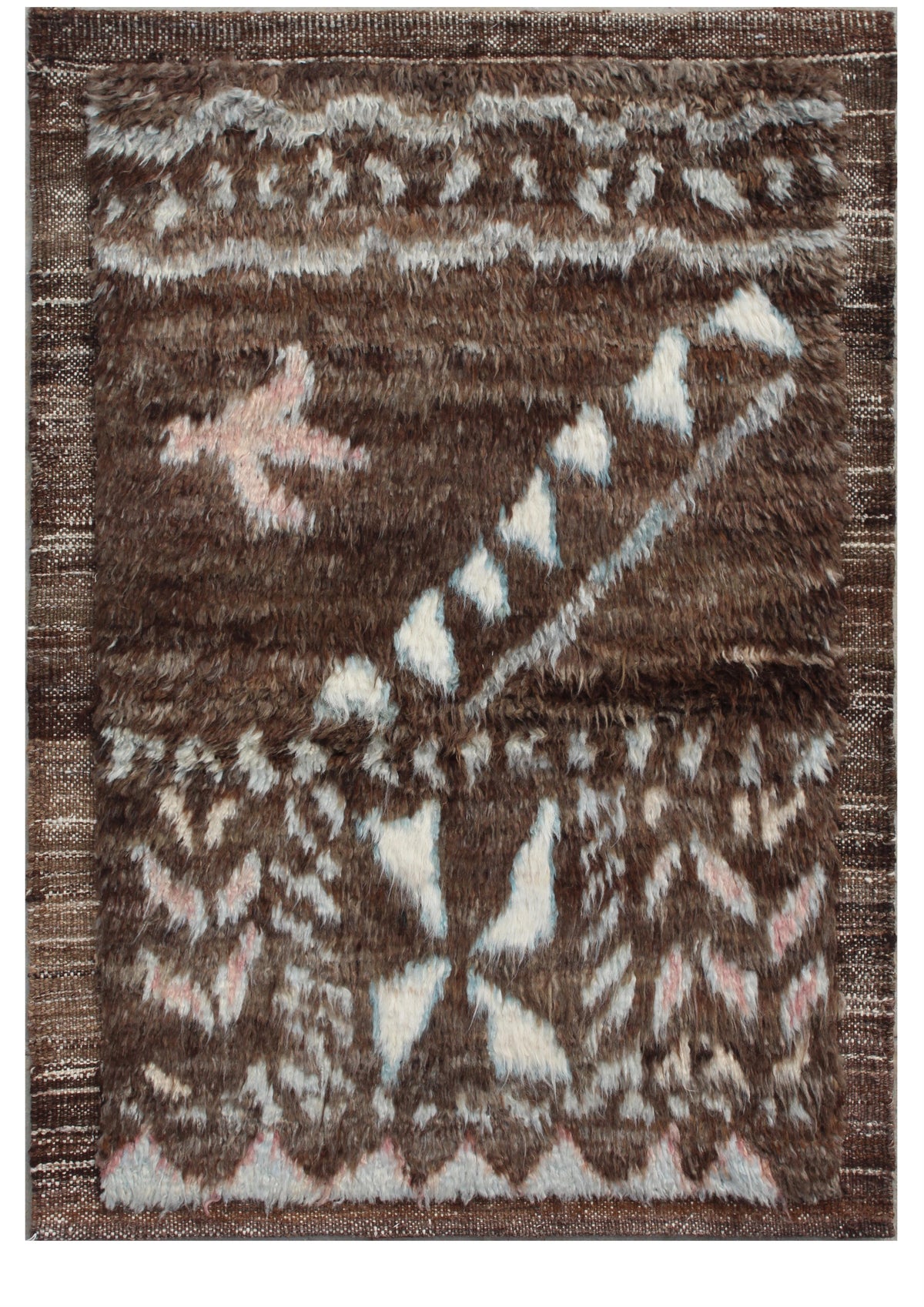 A rectangular area rug with a textured, shaggy surface featuring a brown, beige, and light pink geometric tribal pattern. Atlantica Organics curates antique and handmade rugs, Persian, Afghan, Tibetan, Pakistani, Turkish Oushak, Kilim, Khotan, tribal and contemporary textiles for luxury interiors, homes and real estate. Our collections connect timeless craftsmanship with interior design, furniture, fine art, architecture and modern living. Explore curated rugs, collectible textiles, natural materials, cultu