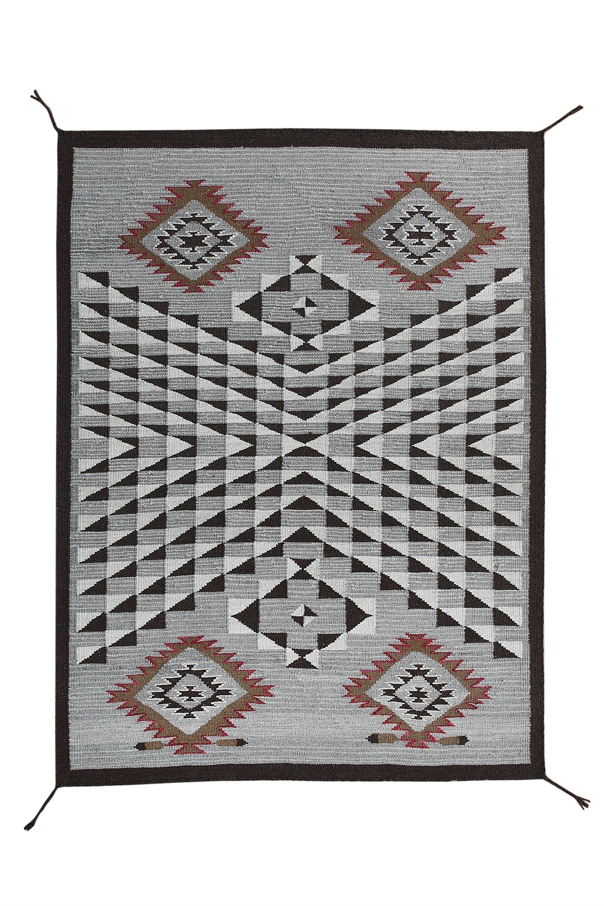 A rectangular woven rug with a Southwestern geometric pattern, featuring black and gray geometric motifs with red and brown diamond accents, set against a plain white background. Atlantica Organics curates antique and handmade rugs, Persian, Afghan, Tibetan, Pakistani, Turkish Oushak, Kilim, Khotan, tribal and contemporary textiles for luxury interiors, homes and real estate. Our collections connect timeless craftsmanship with interior design, furniture, fine art, architecture and modern living. Explore cur