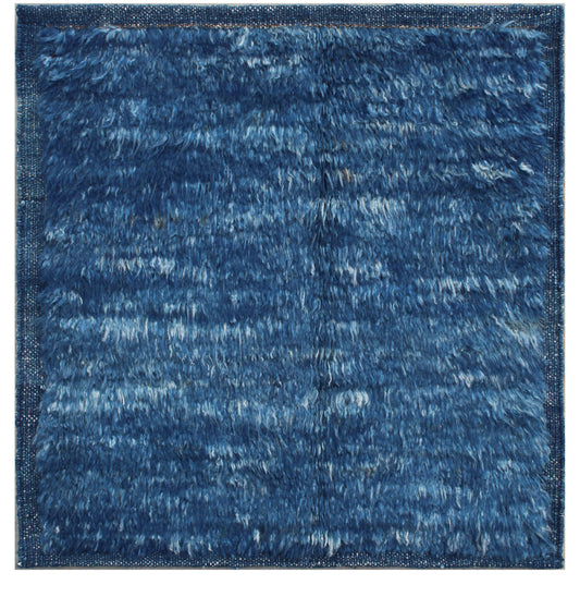 A square blue shag rug with a textured, fluffy pile and a subtle woven border, shown flat against a white background. Atlantica Organics curates antique and handmade rugs, Persian, Afghan, Tibetan, Pakistani, Turkish Oushak, Kilim, Khotan, tribal and contemporary textiles for luxury interiors, homes and real estate. Our collections connect timeless craftsmanship with interior design, furniture, fine art, architecture and modern living. Explore curated rugs, collectible textiles, natural materials, cultural 