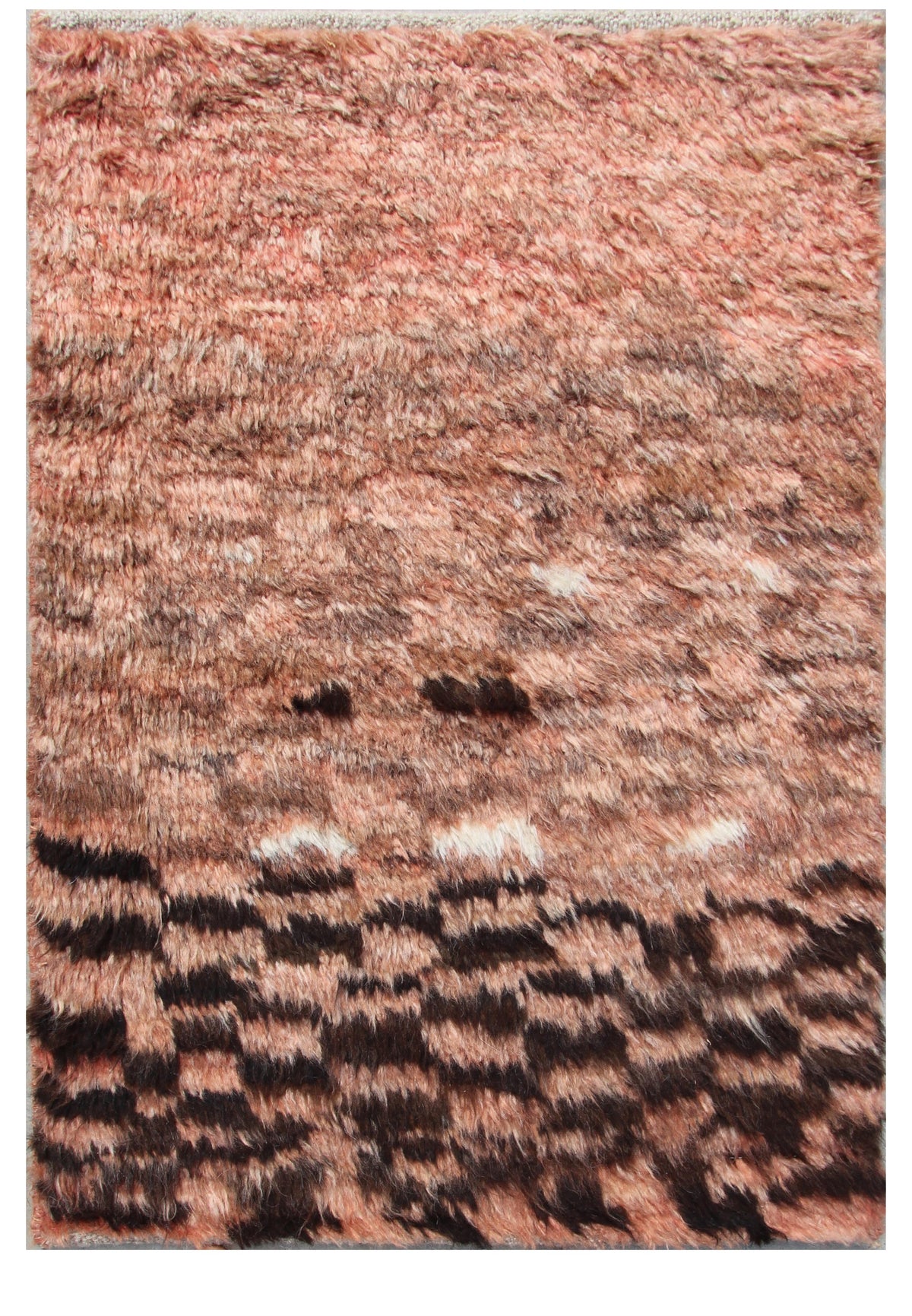 A close-up of a shaggy area rug with a textured, abstract pattern in dusty rose, terracotta, brown, and black. Atlantica Organics curates antique and handmade rugs, Persian, Afghan, Tibetan, Pakistani, Turkish Oushak, Kilim, Khotan, tribal and contemporary textiles for luxury interiors, homes and real estate. Our collections connect timeless craftsmanship with interior design, furniture, fine art, architecture and modern living. Explore curated rugs, collectible textiles, natural materials, cultural heritag