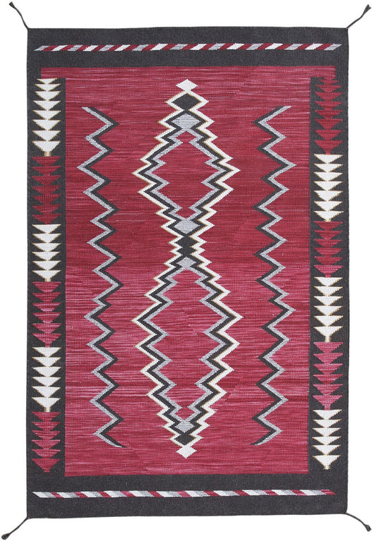 A rectangular woven rug with a Southwestern geometric pattern, featuring a deep red center, black borders, and white and gray zigzag and diamond motifs. Atlantica Organics curates antique and handmade rugs, Persian, Afghan, Tibetan, Pakistani, Turkish Oushak, Kilim, Khotan, tribal and contemporary textiles for luxury interiors, homes and real estate. Our collections connect timeless craftsmanship with interior design, furniture, fine art, architecture and modern living. Explore curated rugs, collectible tex
