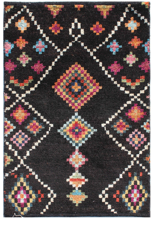 A square black woven rug with a colorful geometric diamond pattern in cream, pink, orange, blue, and yellow. Atlantica Organics curates antique and handmade rugs, Persian, Afghan, Tibetan, Pakistani, Turkish Oushak, Kilim, Khotan, tribal and contemporary textiles for luxury interiors, homes and real estate. Our collections connect timeless craftsmanship with interior design, furniture, fine art, architecture and modern living. Explore curated rugs, collectible textiles, natural materials, cultural heritage,
