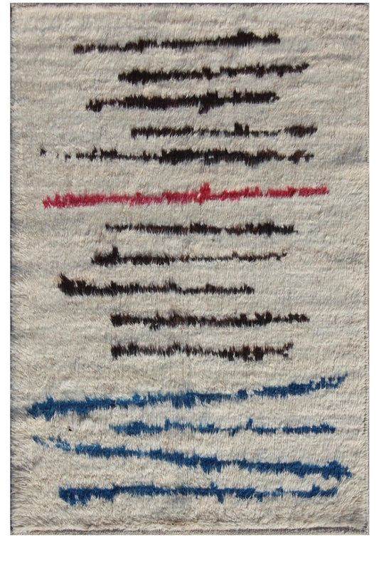 A square area rug with a textured, shaggy surface in a warm off-white or beige tone, decorated with abstract horizontal brushstroke lines in black, red, and blue.Atlantica Organics curates antique and handmade rugs, Persian, Afghan, Tibetan, Pakistani, Turkish Oushak, Kilim, Khotan, tribal and contemporary textiles for luxury interiors, homes and real estate. Our collections connect timeless craftsmanship with interior design, furniture, fine art, architecture and modern living. Explore curated rugs, collec