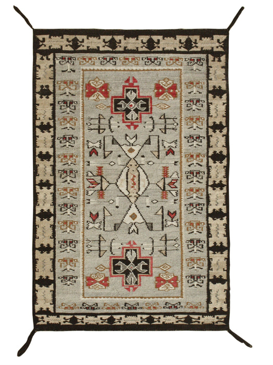 A rectangular Southwestern-style area rug with a cream and beige field, decorated with red, black, and brown geometric patterns and borders, shown flat against a white background. Atlantica Organics curates antique and handmade rugs, Persian, Afghan, Tibetan, Pakistani, Turkish Oushak, Kilim, Khotan, tribal and contemporary textiles for luxury interiors, homes and real estate. Our collections connect timeless craftsmanship with interior design, furniture, fine art, architecture and modern living. Explore cu