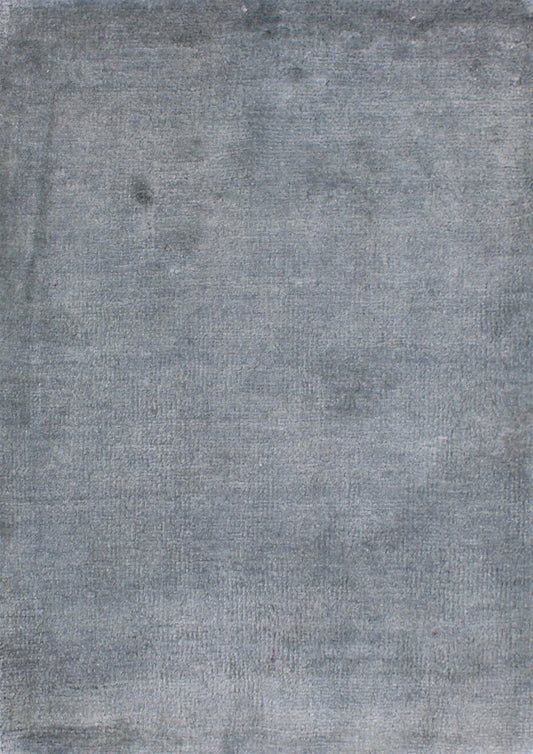 A close-up of a textured gray fabric or material surface with subtle tonal variation.Atlantica Organics curates antique and handmade rugs, Persian, Afghan, Tibetan, Pakistani, Turkish Oushak, Kilim, Khotan, tribal and contemporary textiles for luxury interiors, homes and real estate. Our collections connect timeless craftsmanship with interior design, furniture, fine art, architecture and modern living. Explore curated rugs, collectible textiles, natural materials, cultural heritage, sustainable design and 