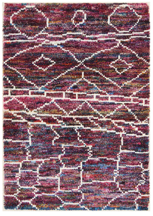 A square area rug with a textured, shaggy pile featuring a geometric tribal pattern in shades of burgundy, purple, blue, and cream. Atlantica Organics curates antique and handmade rugs, Persian, Afghan, Tibetan, Pakistani, Turkish Oushak, Kilim, Khotan, tribal and contemporary textiles for luxury interiors, homes and real estate. Our collections connect timeless craftsmanship with interior design, furniture, fine art, architecture and modern living. Explore curated rugs, collectible textiles, natural materi