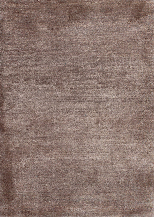 A close-up of a brown textured rug with a soft, plush pile and subtle tonal variation.Atlantica Organics curates antique and handmade rugs, Persian, Afghan, Tibetan, Pakistani, Turkish Oushak, Kilim, Khotan, tribal and contemporary textiles for luxury interiors, homes and real estate. Our collections connect timeless craftsmanship with interior design, furniture, fine art, architecture and modern living. Explore curated rugs, collectible textiles, natural materials, cultural heritage, sustainable design and