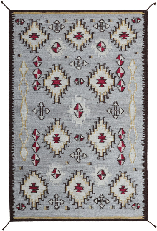 A rectangular woven area rug with a Southwestern geometric pattern, featuring cream, red, and dark brown motifs on a light gray background.