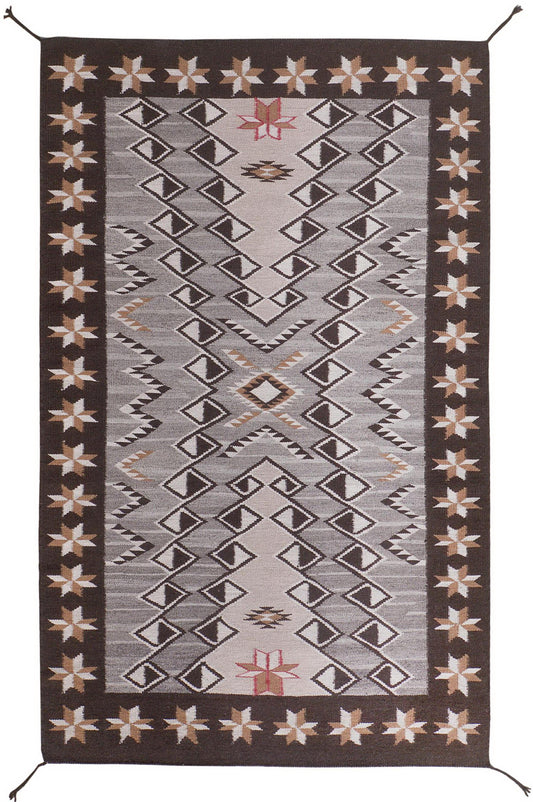 A rectangular woven area rug with a Southwestern geometric pattern, featuring a dark brown border, a light gray center, and beige and rust accents. Atlantica Organics curates antique and handmade rugs, Persian, Afghan, Tibetan, Pakistani, Turkish Oushak, Kilim, Khotan, tribal and contemporary textiles for luxury interiors, homes and real estate. Our collections connect timeless craftsmanship with interior design, furniture, fine art, architecture and modern living. Explore curated rugs, collectible textiles