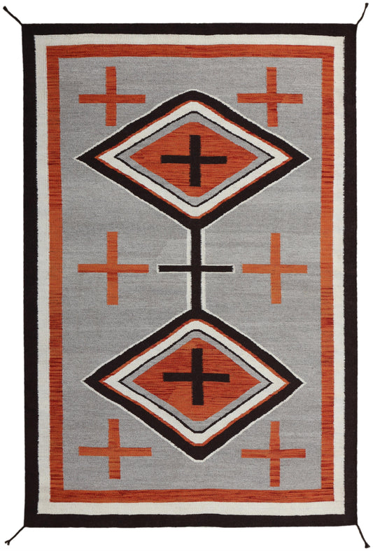 A rectangular woven rug with a Southwestern geometric design, featuring two large diamond motifs and five orange crosses on a gray background with a black and orange border.