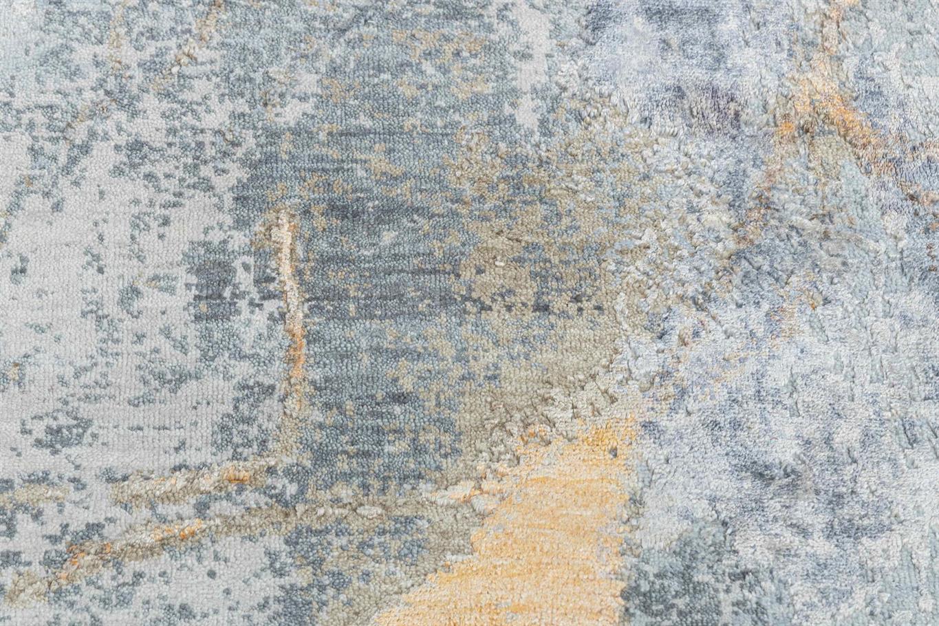 Close-up of a textured rug with gray, beige, and brown colors. Atlantica Organics curates antique and handmade rugs, Persian, Afghan, Tibetan, Pakistani, Turkish Oushak, Kilim, Khotan, tribal and contemporary textiles for luxury interiors, homes and real estate. Our collections connect timeless craftsmanship with interior design, furniture, fine art, architecture and modern living. Explore curated rugs, collectible textiles, natural materials, cultural heritage, sustainable design and distinctive spaces for