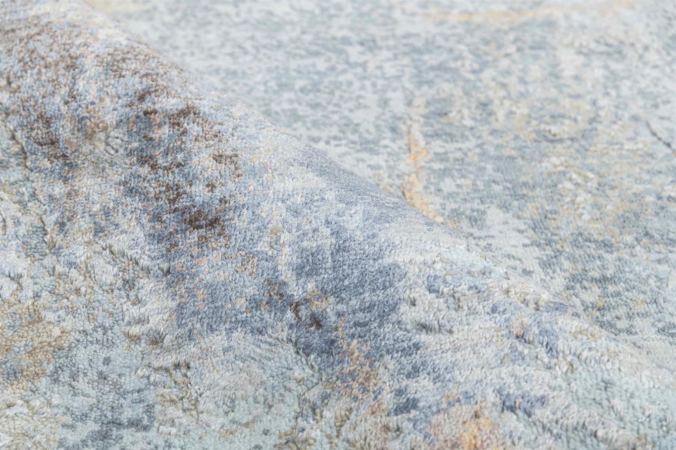 Close-up of a textured stone surface with gray and brown tones Atlantica Organics curates antique and handmade rugs, Persian, Afghan, Tibetan, Pakistani, Turkish Oushak, Kilim, Khotan, tribal and contemporary textiles for luxury interiors, homes and real estate. Our collections connect timeless craftsmanship with interior design, furniture, fine art, architecture and modern living. Explore curated rugs, collectible textiles, natural materials, cultural heritage, sustainable design and distinctive spaces for