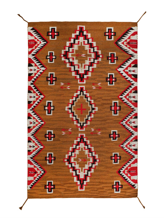 A rectangular woven rug with a Southwestern geometric pattern, featuring a warm brown base with red, black, and white diamond motifs and zigzag borders, shown flat against a white background. Atlantica Organics curates antique and handmade rugs, Persian, Afghan, Tibetan, Pakistani, Turkish Oushak, Kilim, Khotan, tribal and contemporary textiles for luxury interiors, homes and real estate. Our collections connect timeless craftsmanship with interior design, furniture, fine art, architecture and modern living