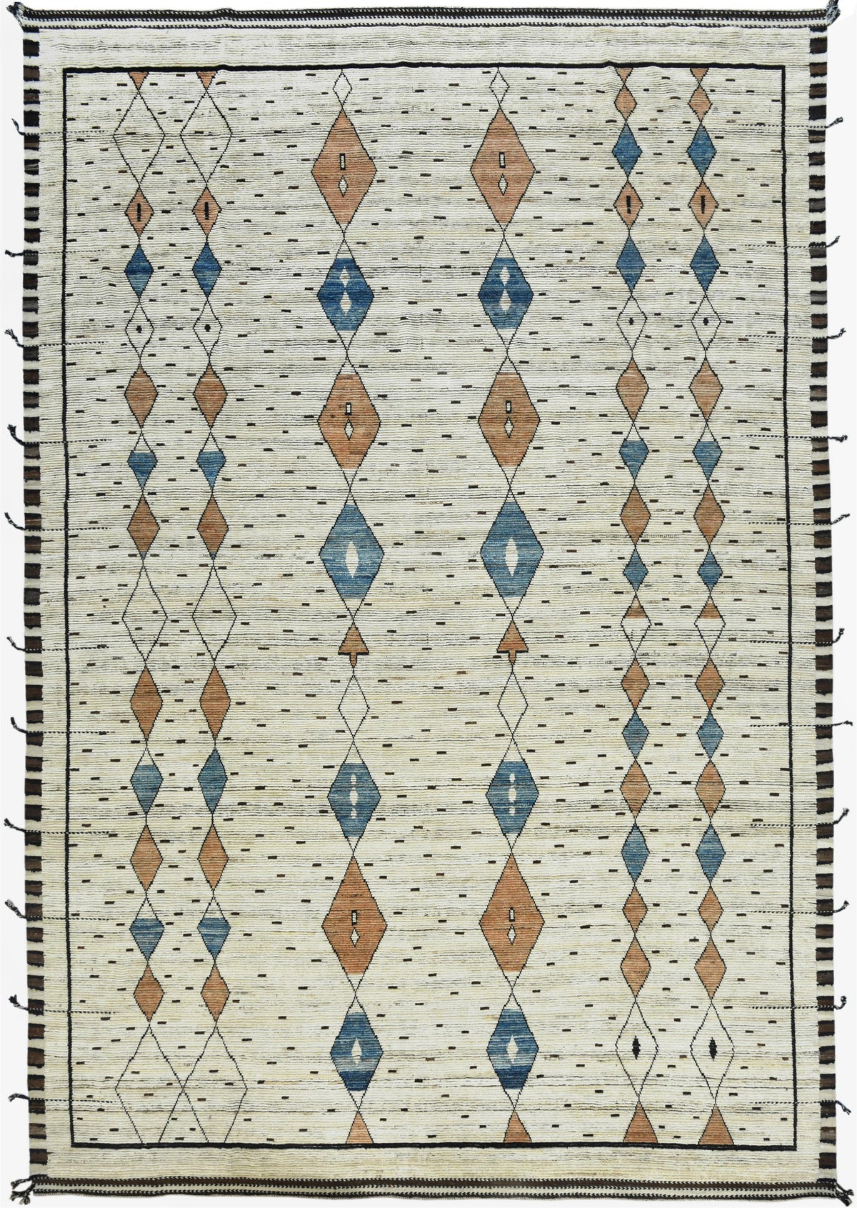 A square woven rug with a cream-colored base, featuring vertical columns of diamond motifs in blue, terracotta orange, and brown, bordered by black and white stripes with black tassels. Atlantica Organics curates antique and handmade rugs, Persian, Afghan, Tibetan, Pakistani, Turkish Oushak, Kilim, Khotan, tribal and contemporary textiles for luxury interiors, homes and real estate. Our collections connect timeless craftsmanship with interior design, furniture, fine art, architecture and modern living. Expl