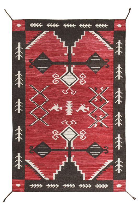 A rectangular woven rug with a Southwestern geometric pattern, featuring a vibrant red field, dark brown borders, and off-white accents. Atlantica Organics curates antique and handmade rugs, Persian, Afghan, Tibetan, Pakistani, Turkish Oushak, Kilim, Khotan, tribal and contemporary textiles for luxury interiors, homes and real estate. Our collections connect timeless craftsmanship with interior design, furniture, fine art, architecture and modern living. Explore curated rugs, collectible textiles, natural m